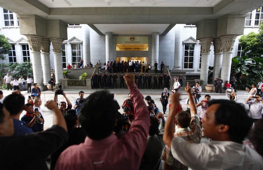 Supporters of Malaysian opposition leader Datuk Seri Anwar Ibrahim shout 'Free Anwar' outside the court house in Putrajaya March 7, 2014. u00e2u20acu201d Reuters pic