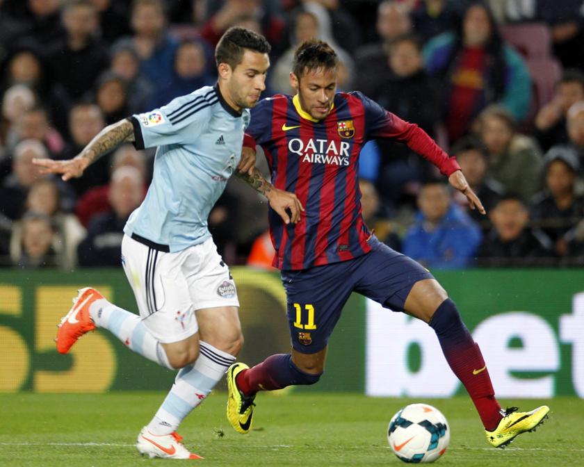 Barcelona's Neymar (right) fights for the ball with Celta Vigo's Hugo Mallo during their La Liga match at Camp Nou stadium in Barcelona March 26, 2014. u00e2u20acu2022 Reuters pic