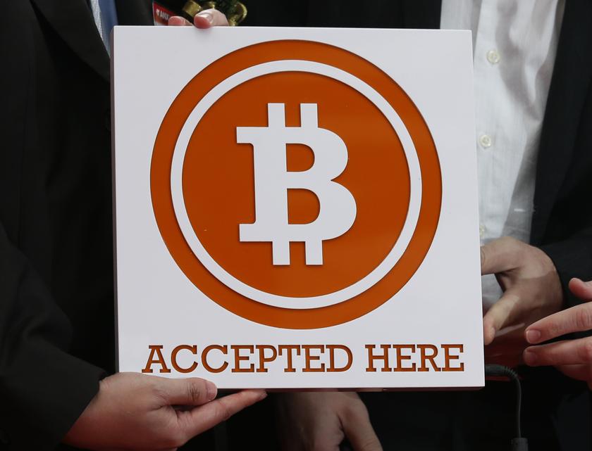 A bitcoin sign is held outside Hong Kong's first bitcoin retail store during its opening, in Hong Kong February 28, 2014. u00e2u20acu201d Reuters pic