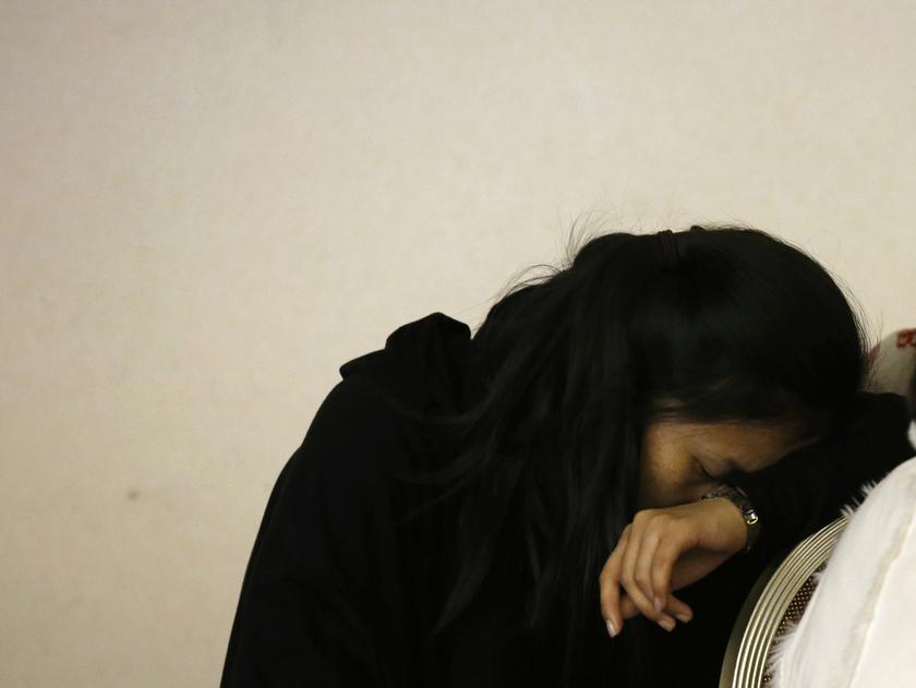 A family member of a passenger onboard the missing Malaysia Airlines Flight MH370 reacts during a briefing from the Malaysia Airlines at a hotel in Beijing March 14, 2014. u00e2u20acu201d Reuters pic