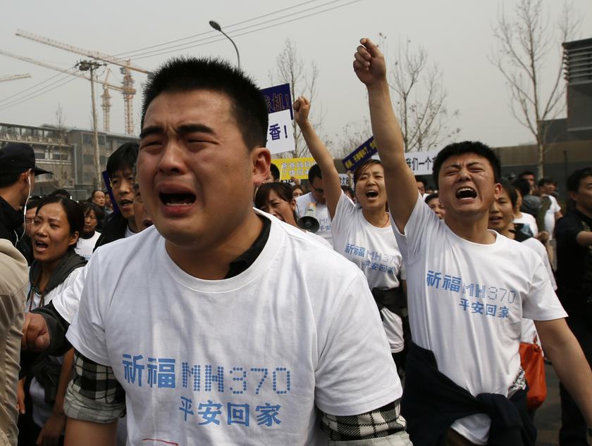 Family members of passengers on board Malaysia Airlines MH370 cry as they shout slogans during a protest in front of the Malaysian embassy in Beijing March 25, 2014. u00e2u20acu201d Reuters pic