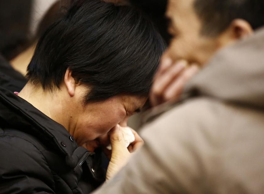 A mother of a passenger on board the missing Malaysia Airlines flight MH370 cries as she listens to a briefing from the airline company at a hotel in Beijing, March 18, 2014. u00e2u20acu201d Reuters pic