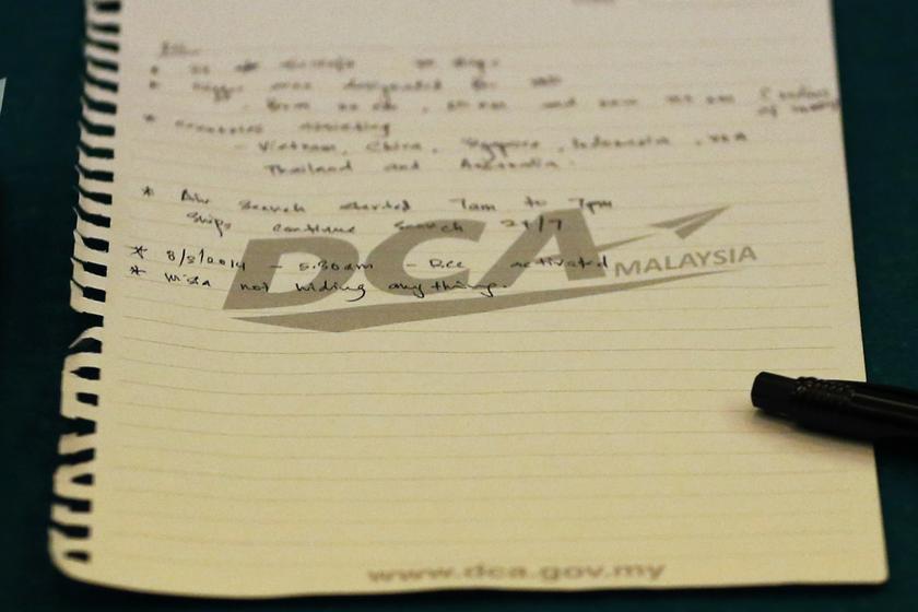 A handwritten note is seen on the table during a joint working group sent by the Chinese government to Malaysia after the disappearance of Malaysia Airlines flight MH370, at a hotel at the Kuala Lumpur International Airport March 12, 2014. u00e2u20acu201d Reuters pic