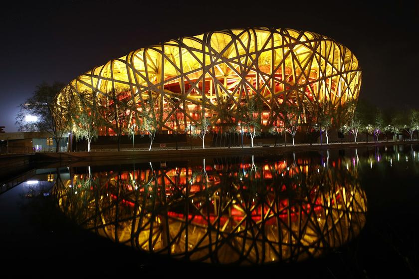 The National Stadium, also known as the u00e2u20acu02dcBirdu00e2u20acu2122s Nestu00e2u20acu2122, is seen reflected in a lake before Earth Hour at the Olympic Park in Beijing, March 29, 2014. u00e2u20acu201d Reuters pic