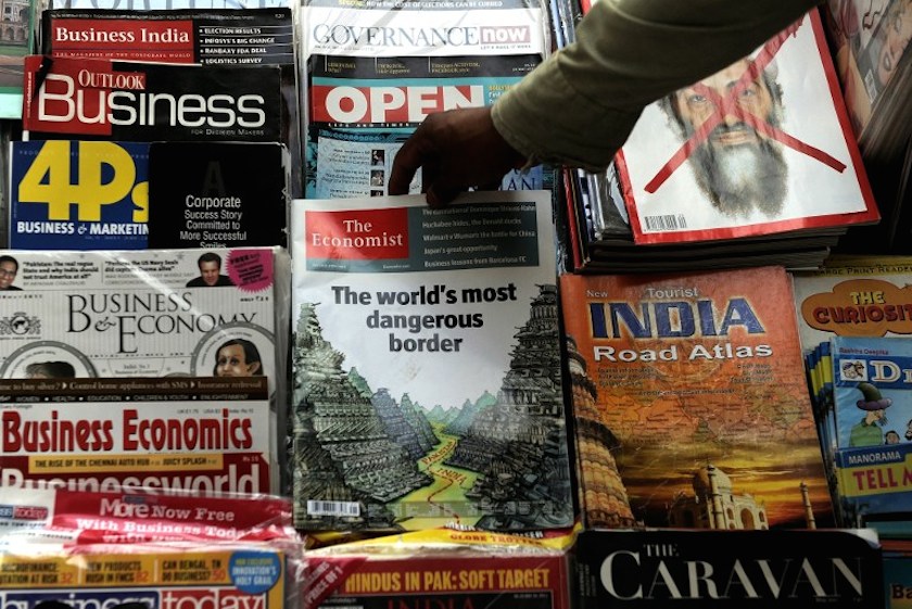 An Indian magazine vendor arranges a censored issue of the Economist magazine at a road-side stall in New Delhi on May 24, 2011. u00e2u20acu201d AFP pic