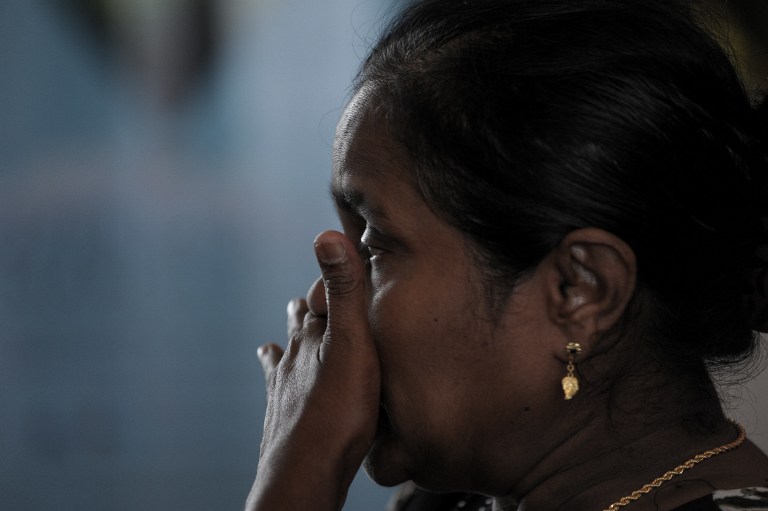 A relative of victims from the missing Malaysia Airlines Boeing 777-200 plane cries while awaiting updates at a hotel in Putrajaya, outside Kuala Lumpur on March 10, 2014. — AFP pic