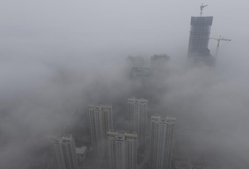 Buildings are seen shrouded in heavy haze at Qingdao development zone, Shandong province, February 25, 2014. u00e2u20acu201d Reuters pic