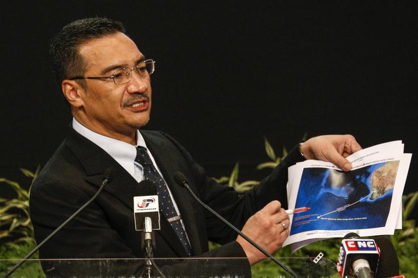 Malaysiau00e2u20acu2122s acting Transport Minister Datuk Seri Hishammuddin Hussein holds satellite images during a news conference at Putra World Trade Centre in Kuala Lumpur March 26, 2014. u00e2u20acu201d Reuters pic