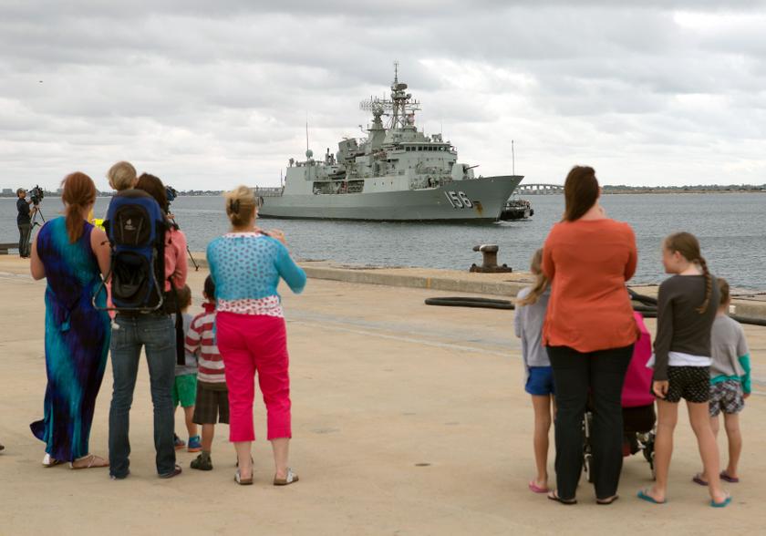 Family and friends watch Australian Navy frigate HMAS Toowoomba arrive at the Australian naval base Fleet Base West to replenish stores and join the search for missing Malaysian Airlines flight MH370, in this picture released by the Australian Defence Force March 29, 2014. 