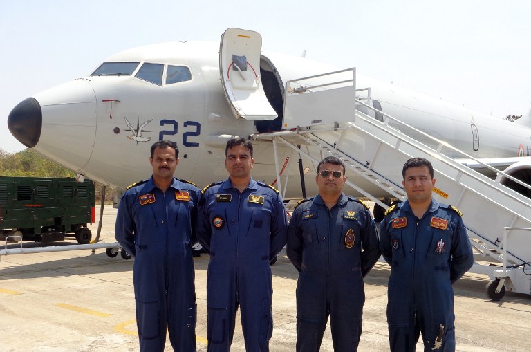 In this photograph released by the Indian Navy on March 15, 2014, Indian naval officers pose for a photograph during a search for a missing Malaysian jet in the Bay of Bengal and Andaman Sea. u00e2u20acu201d AFP pic
