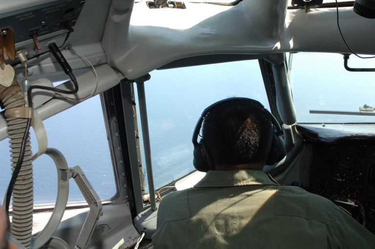 This handout photograph released by the Indonesian Air Force on March 13, 2014 shows an Indonesian Air Force pilot aboard an Indonesian Air Force military surveillance aircraft over the Malacca Strait. u00e2u20acu201d AFP pic
