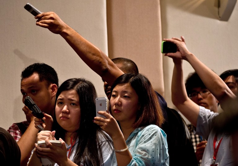 Journalists listen as  Prime Minister Datuk Seri Najib Razak reads a statement during a press conference at a hotel near Kuala Lumpur International Airport in Sepang on March 15, 2014. u00e2u20acu201d AFP pic