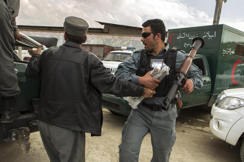 A policeman holds an RPG launcher as he prepares to run toward the Independent Election Commission office during an attack by insurgents in Kabul March 29, 2014. u00e2u20acu201d Reuters pic