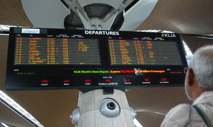 A man looking at the flight information board at the Kuala Lumpur International Airport (KLIA) in Sepang, March 9, 2014. u00e2u20acu201d Picture by Mohd Yusof Mat Isan