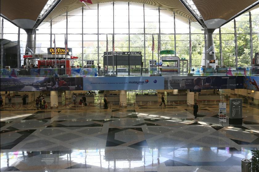 Only a handful of passengers are at the immigration counters at the KLIA departure hall in Sepang march 17,2014.  u00e2u20acu201d Picture by Saw Siow Feng