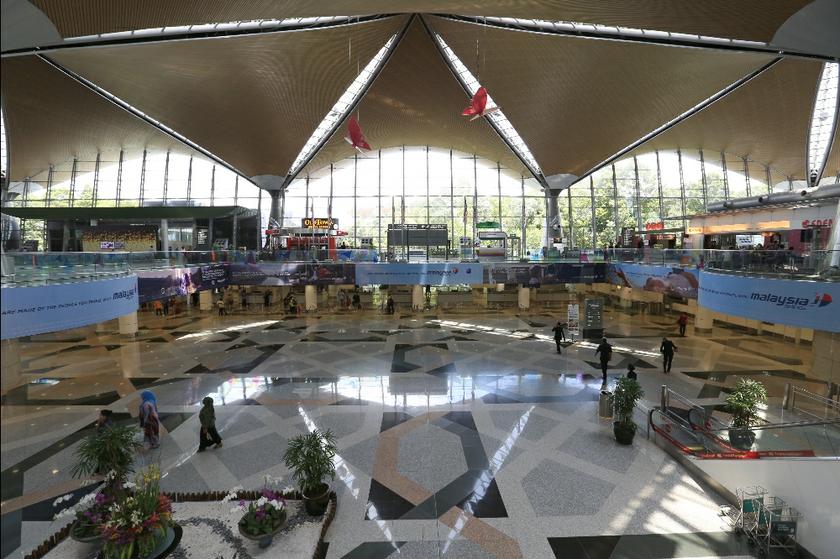 Only a handful of passengers are at the immigration counters at the KLIA departure hall in Sepang march 17,2014.  u00e2u20acu201d Picture by Saw Siow Feng