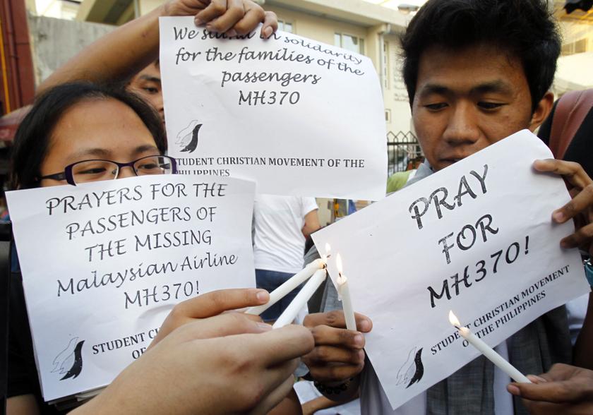 Students light candles during a vigil to show their support for the passengers of the missing Malaysia Airlines Flight MH370, in Manila March 13, 2014. u00e2u20acu201d Reuters pic