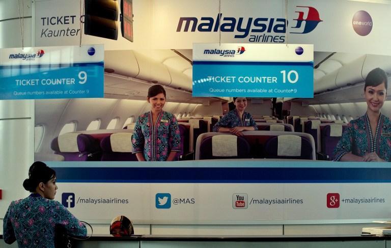A Malaysia Airlines crew member stands at an empty ticket counter at the Kuala Lumpur International Airport in Sepang March 8, 2014. u00e2u20acu201d AFP pic