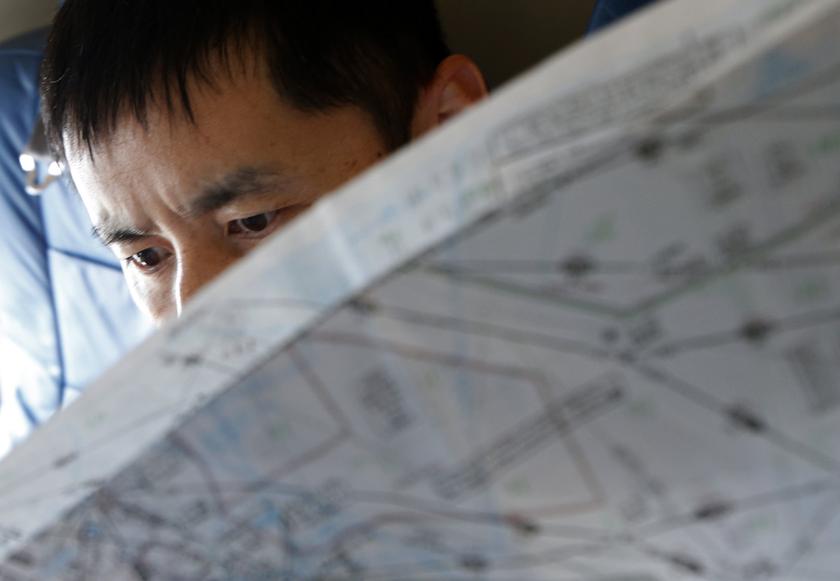A Japan Coast Guard officer studies a map onboard their Gulfstream V Jet aircraft, customized for search and rescue operations, as they search for the missing Malaysia Airlines MH370 plane over the waters of the South China Sea March 15, 2014. u00e2u20acu201d Reuters
