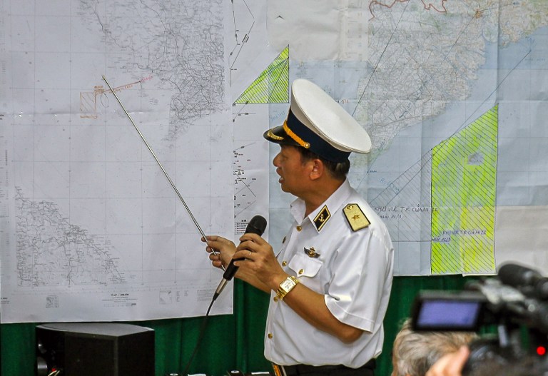 Vietnamese Navy's Deputy Commander Rear Admiral Le Minh Thanh points at a map to show the area where Vietnam is conducting search activities for the missing Malaysia Airlines flight 370 in Phu Quoc island on March 12, 2014. u00e2u20acu201d AFP pic