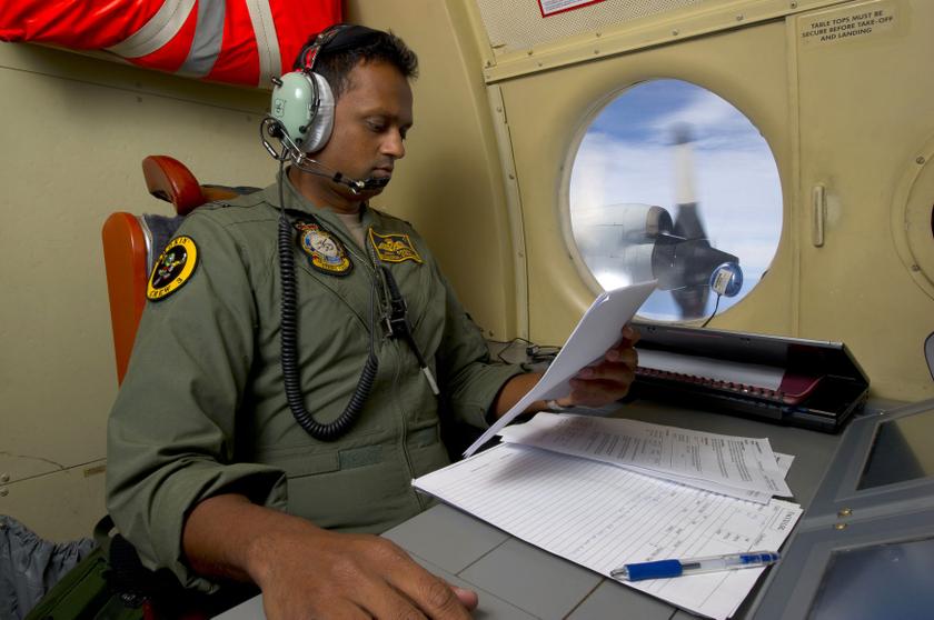 Royal Australian Air Force Tactical Coordinator, Flying Officer Imray Cooray from 10 Squadron, coordinates with fellow crew members aboard an AP-3COrion during the search for missing Malaysian Airlines flight MH370, March 20, 2014. Reuters pic