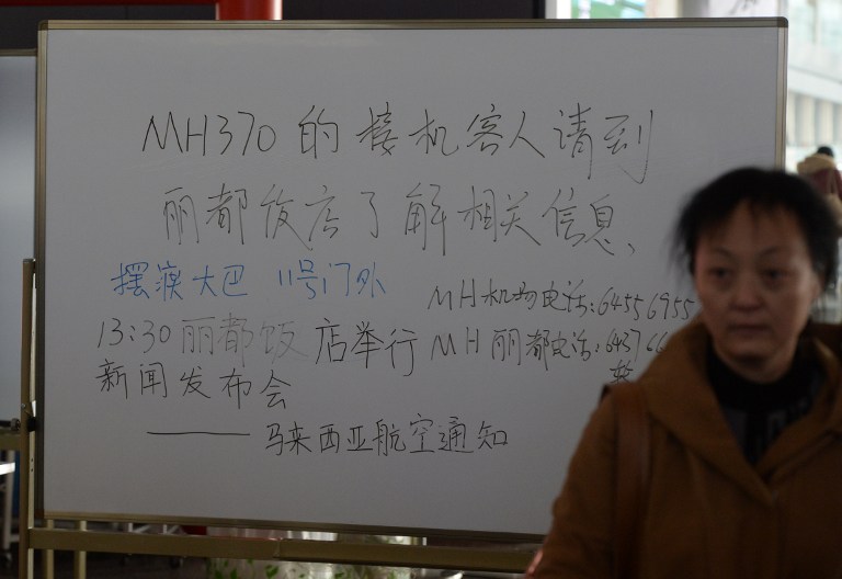 A signboard advises relatives of passengers of a missing Malaysia Airlines to go to a nearby hotel for information on the flight, at Beijing International Airport in Beijing on March 8, 2014. u00e2u20acu201d AFP pic