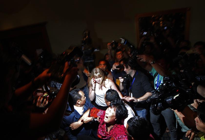 A Chinese family member of a passenger onboard the missing Malaysia Airlines Flight MH370 screams outside the media conference area at a hotel in Kuala Lumpur International Airport March 19, 2014. u00e2u20acu201d Reuters pic