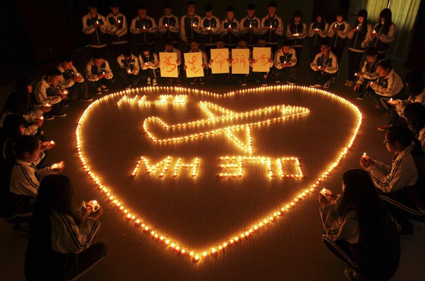 International school students light candles to pray for passengers aboard Malaysia Airlines flight MH370, in Zhuji, Zhejiang province, March 10, 2014. u00e2u20acu201d Reuters pic