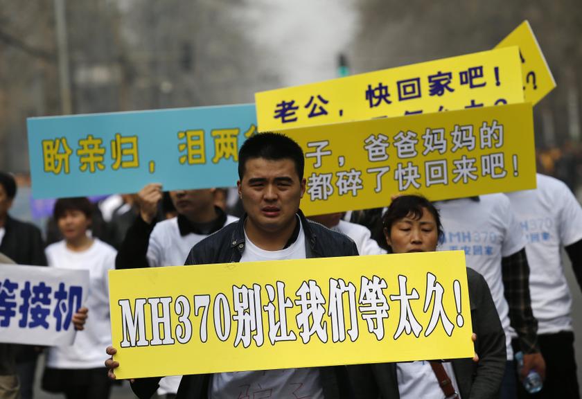 Family members of passengers on board Malaysia Airlines Flight MH370 protest as they head to the Malaysian Embassy from Lido hotel in Beijing March 25, 2014. — Reuters pic