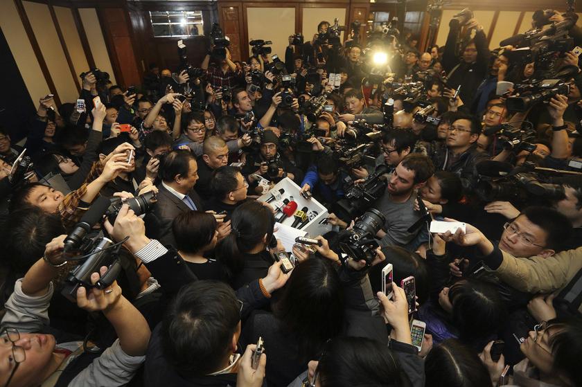 A spokesman (centre) of Malaysia Airlines is surrounded by journalists as he gives a briefing about Malaysia Airlines flight MH370, at a hotel in Beijing March 9, 2014. u00e2u20acu201d Reuters pic