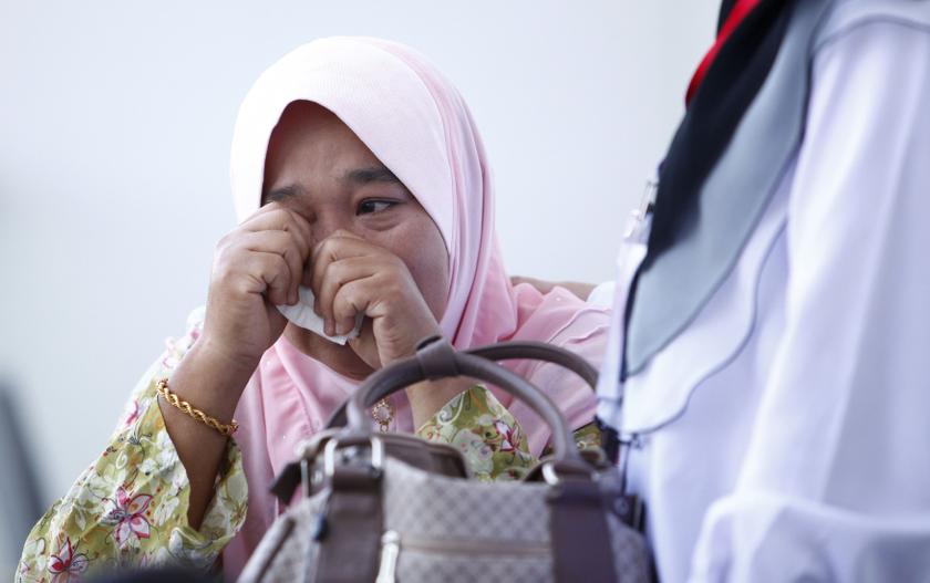 A family member of passengers onboard the missing Malaysia Airlines flight MH370 cry inside a hotel they are staying at in Putrajaya March 11, 2014. u00e2u20acu201d Reuters pic