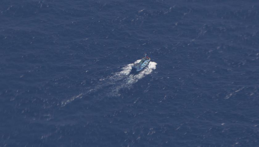 An unidentified search and rescue ship is seen through the window of a Vietnam Air Force aircraft AN-26 during a mission to find the missing MH370, that disappeared from radar screens in the early hours of Saturday, off Con Dao island March 12, 2014. u00e2u20acu201d 