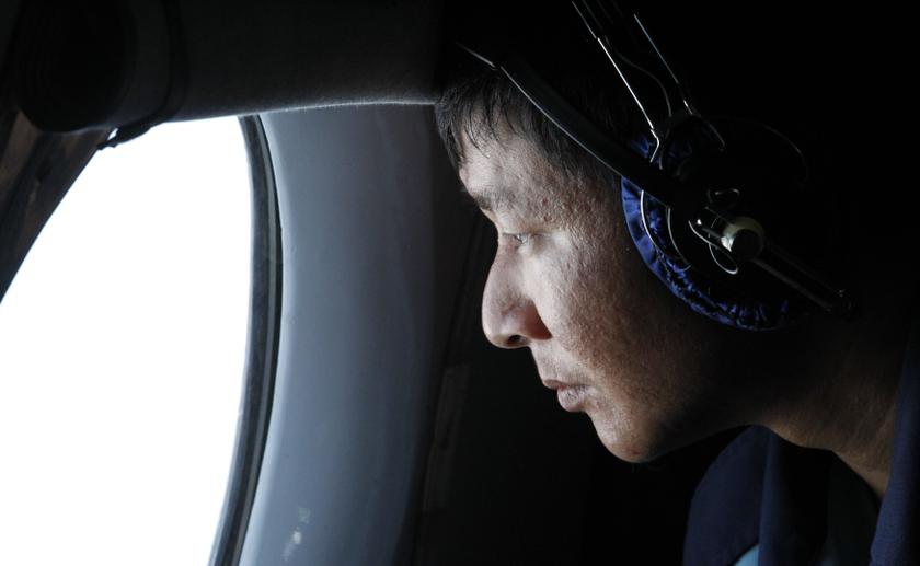 A military officer looks out a window during a search and rescue mission onboard an aircraft belonging to the Vietnamese airforce off Vietnamu00e2u20acu2122s Tho Chu island March 10, 2014. u00e2u20acu201d Reuters pic
