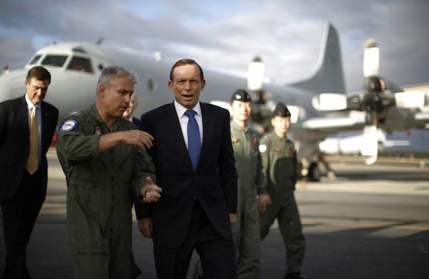 Australia's Prime Minister Tony Abbott is guided around a Royal Australian Air Force P-3C Orion aircraft by Australia's Air Force Group Commander Craig Heap (2nd L) during Abbott's visit to RAAF Base Pearce near Perth March 31, 2014. u00e2u20acu2022 Reuters pic