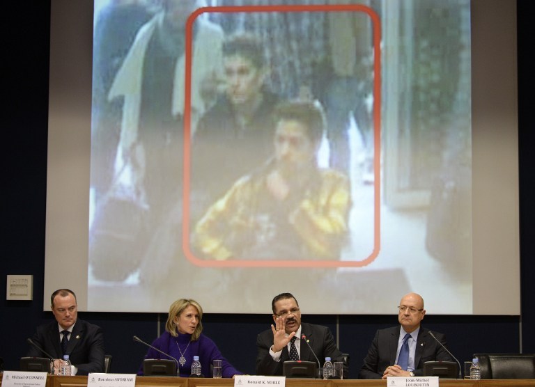 Interpol Secretary General Ronald Kenneth Noble (second from right) speaks during a press conference where they display an image of two suspects from MH370 on March 11, 2014. u00e2u20acu201d AFP pic