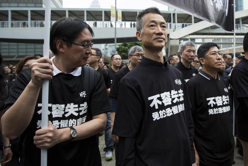 Ming Pao chief editor Cheung Kin Bor (centre) and chief executive editor Chong Tien Siong (right), attend the march against violence on journalists in Hong Kong March 2,2014. u00e2u20acu201du00c2u00a0Reuters pic