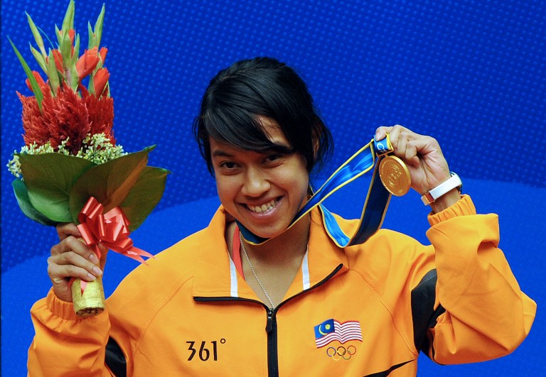Gold medalist Nicol David of Malaysia celebrates on the podium during the medal ceremony of the squash womens's individual final at the 16th Asian Games in Guangzhou on November 21, 2010. u00e2u20acu201d AFP pic