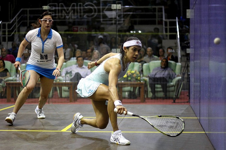 Datuk Nicol David of Malaysia (right) returns a shot against Egypt's Nour El Sherbini (left) during their CIMB Women's World Championship semi-final match at the Spice Arena on March 22, 2014 in George Town, Penang. u00e2u20acu201d AFP pic