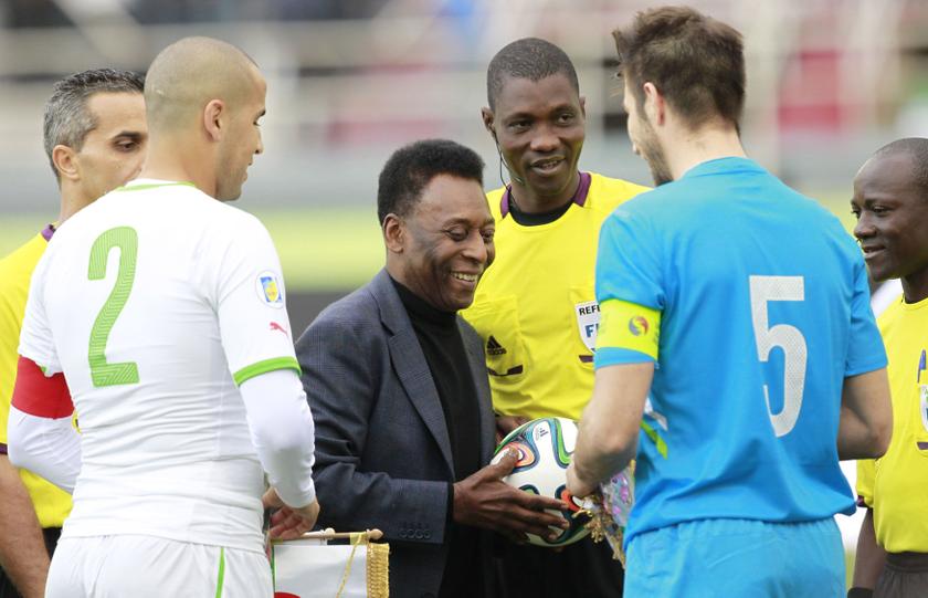 Brazilian football legend Pele (centre) holds a ball during the international friendly match between Algeria and Slovenia in Algiers March 5, 2014. u00e2u20acu2022 Reuters pic