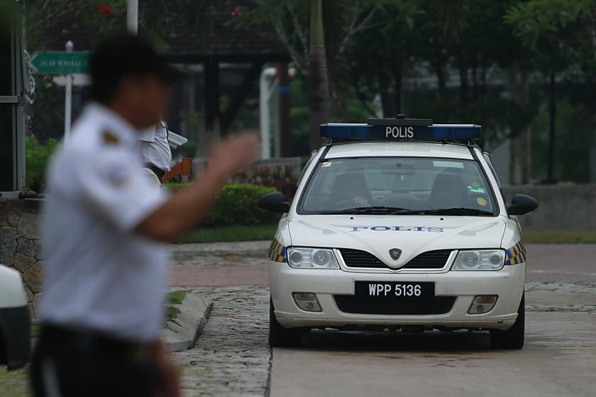 A police car is seen coming from the compound of the home of pilot Zaharie Ahmad Shah, the captain of Malaysia Airlines flight MH370, in Shah Alam, near Kuala Lumpur March 16, 2014. u00e2u20acu201du00c2u00a0Reuters pic