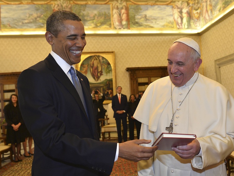 File picture shows Pope Francis (right) talking with US President Barack Obama as they exchange gifts during a private audience at the Vatican City March 27, 2014. — Reuters pic