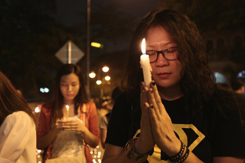 Malaysians pray during a candlelight vigil for the passengers of Malaysia Airlines MH370 near Dataran Merdeka in Kuala Lumpur March 10, 2014. u00e2u20acu201d Picture by Saw Siow Feng