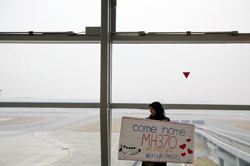 A woman holds a sign of support and hope for the passengers of the missing Malaysia Airlines flight MH370 she made and brought to the Kuala Lumpur International Airport March 11, 2014. u00e2u20acu201d Reuters pic