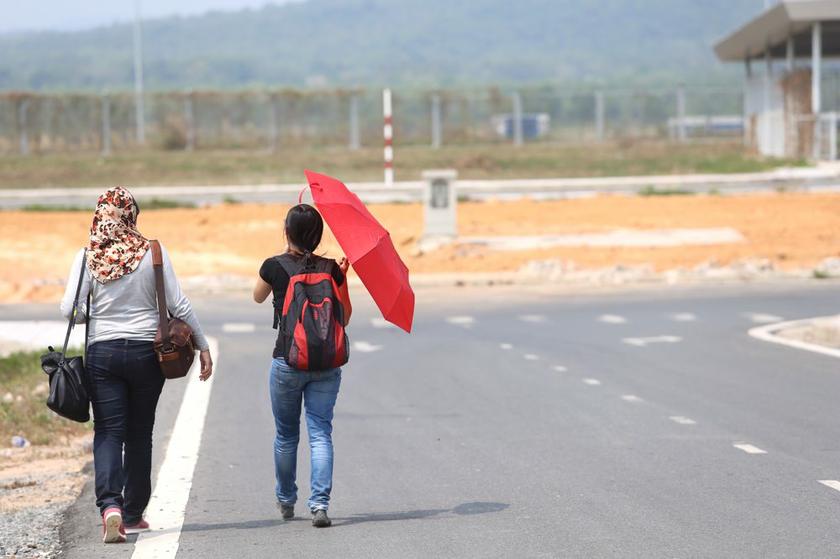 Two reporters walk from Phu Quoc airport in Vietnam to the air traffic control tower nearby that is some 15 minutes away.