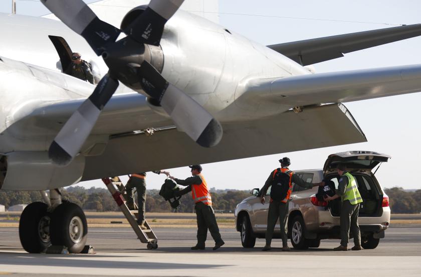Royal Australian Air Force (RAAF) AP-3C Orion crew members unload equipment after returning from a search for Malaysian Airlines flight MH370, at RAAF Base Pearce north of Perth, Australia, March 21, 2014. u00e2u20acu201d Reuters pic