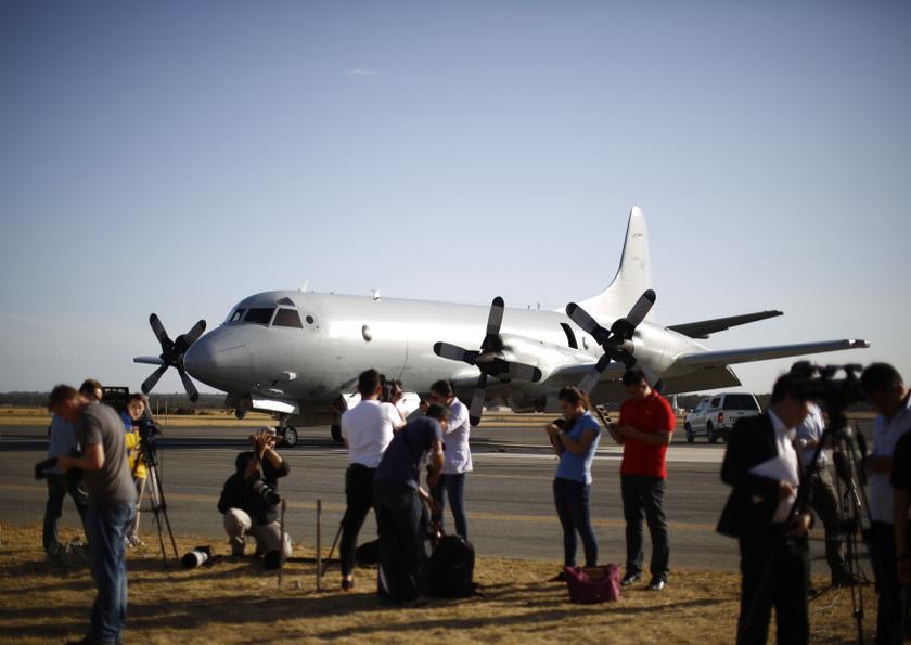 International television crews film alongside a Royal Australian Air Force (RAAF) AP-3C Orion aircraft which had just returned from a search for Malaysian Airlines flight MH370, at RAAF Base Pearce north of Perth, March 21, 2014. u00e2u20acu201d Reuters pic