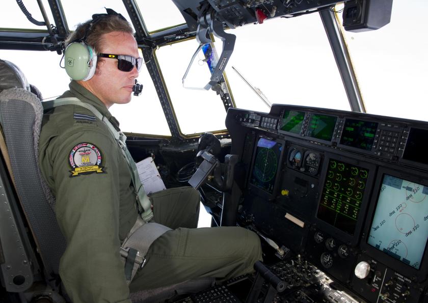 Royal Australian Air Force (RAAF) Pilot Flight Lieutenant Conan Brett prepares to launch two Self Locating Data Marker during the search for the missing flight MH370 in this picture released by the Australian Defence Force March 21, 2014. u00e2u20acu201d Reuters pic