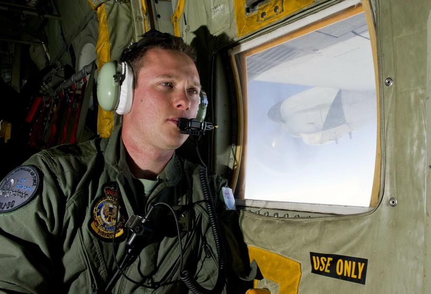 Royal Australian Air Force (RAAF) Loadmaster Sergeant Adam Roberts scans the ocean while on board a C-130J Hercules during the search for missing Malaysian Airlines flight MH370 in this picture released by the Australian Defence Force March 21, 2014. u00e2u20acu201d 