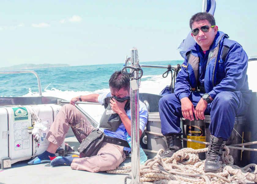A MMEA personnel tending to a photographer badly affected by seasickness. 