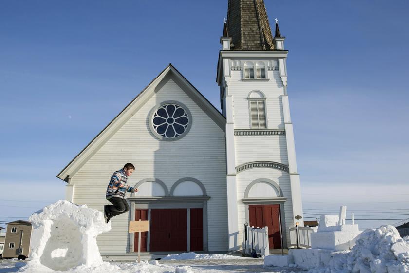 A boy jumps from a snow sculpture during celebrations for the end of the Iditarod dog sled race in Nome, Alaska, March 11, 2014.u00c2u00a0u00e2u20acu201d Reuters pic